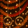 GoHooked set of 2 matte gold round hanging tealight holders with intricate cutwork and chains. Festive decor.