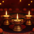 GoHooked matte gold metal square floral cut tealight holder with burning candle, set of 2