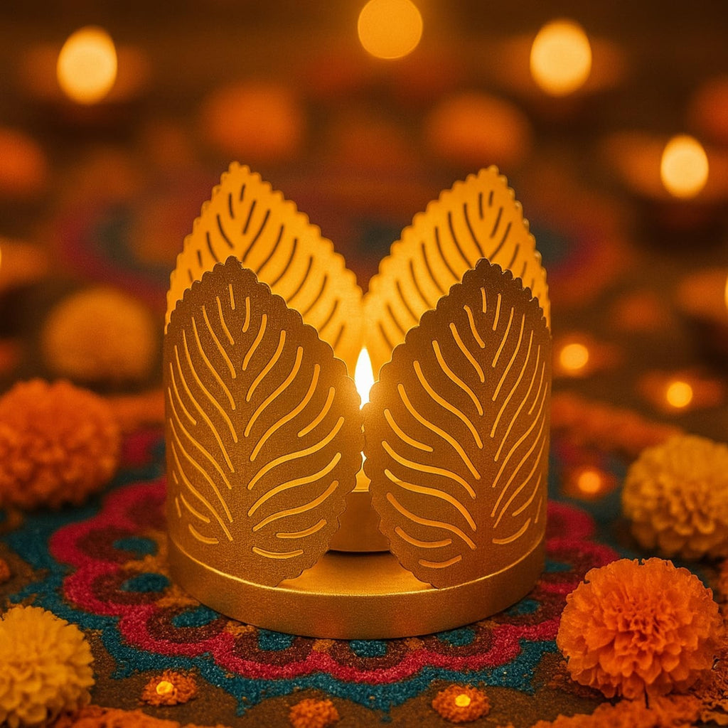 Go Hooked matte gold metal tealight holder with leaf cutouts, casting warm light. Set of 4.