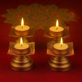 Go Hooked set of 4 matte gold metal tealight candle holders with floral cutouts, perfect for Diwali decor.