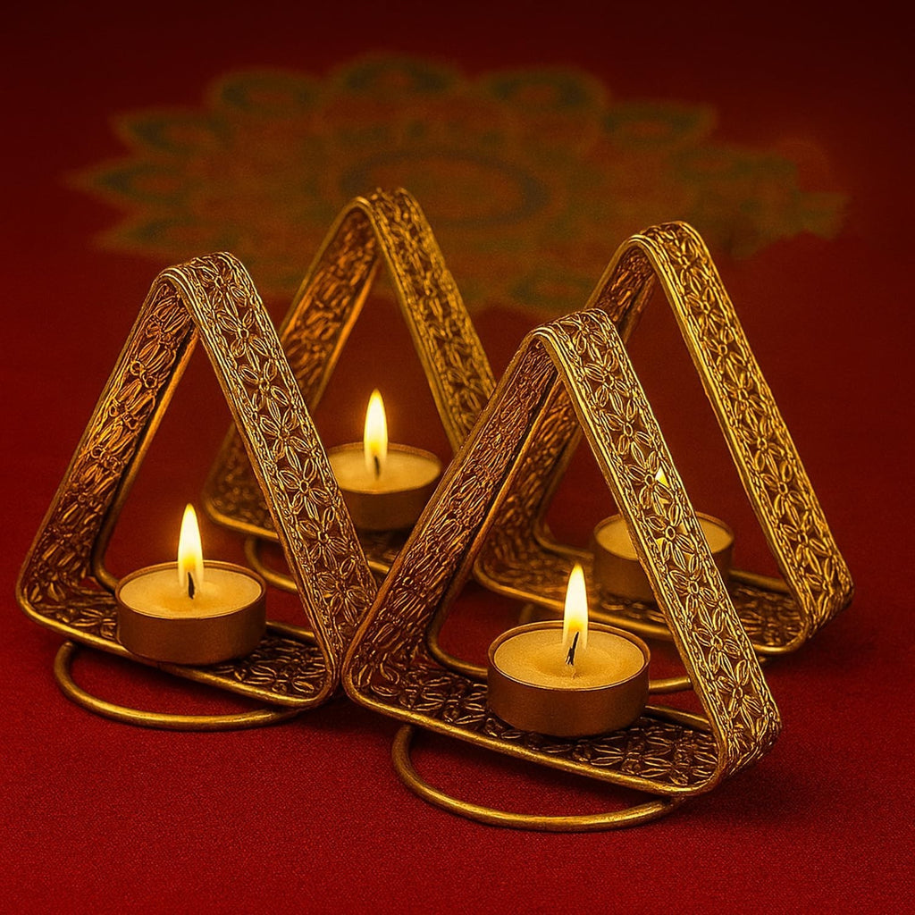 GoHooked set of 4 matte gold triangular tealight holders with floral cutwork and lit candles.