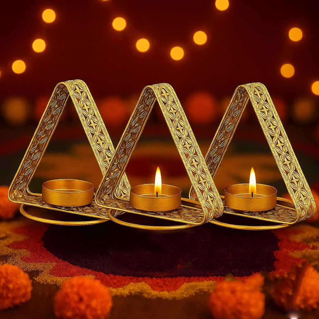 Go Hooked set of 3 matte gold metal triangular tealight holders with floral cutwork design.