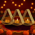 Go Hooked set of 3 matte gold metal triangular tealight holders with floral cutwork design.