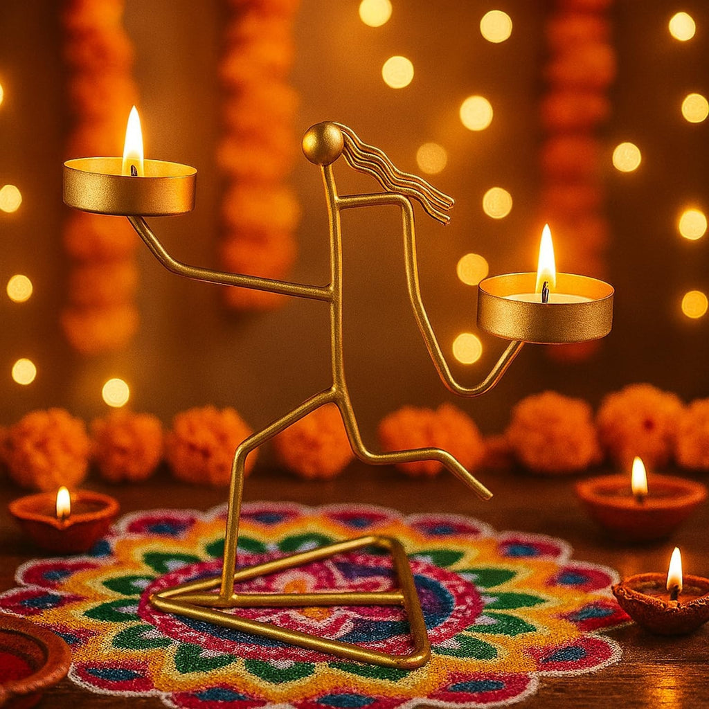 Go Hooked matte gold metal tealight candle holder in a running figurine design with dual trays, set on a colorful rangoli.