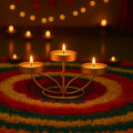 Go Hooked matte gold metal tabletop tealight candle holder with 3 trays, perfect for Diwali decor.