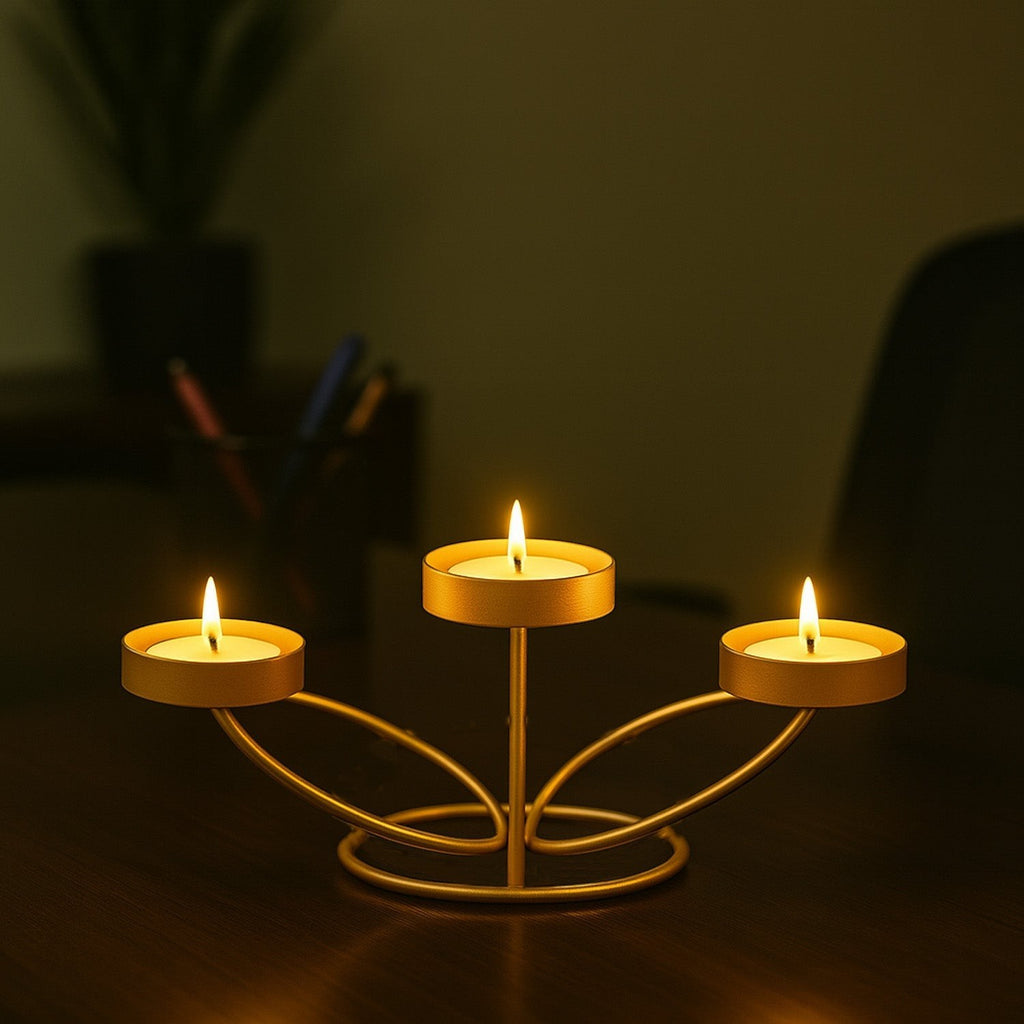 Go Hooked matte gold metal tabletop tealight candle holder with three lit candles, 25cm decorative iron stand