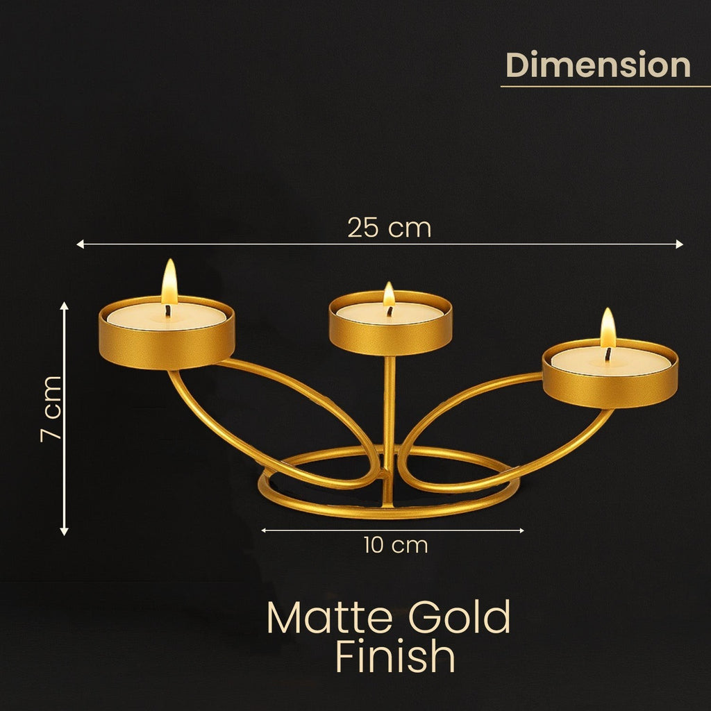 Go Hooked matte gold metal tabletop tealight candle holder with 3 slots, 25cm long, for home decor.