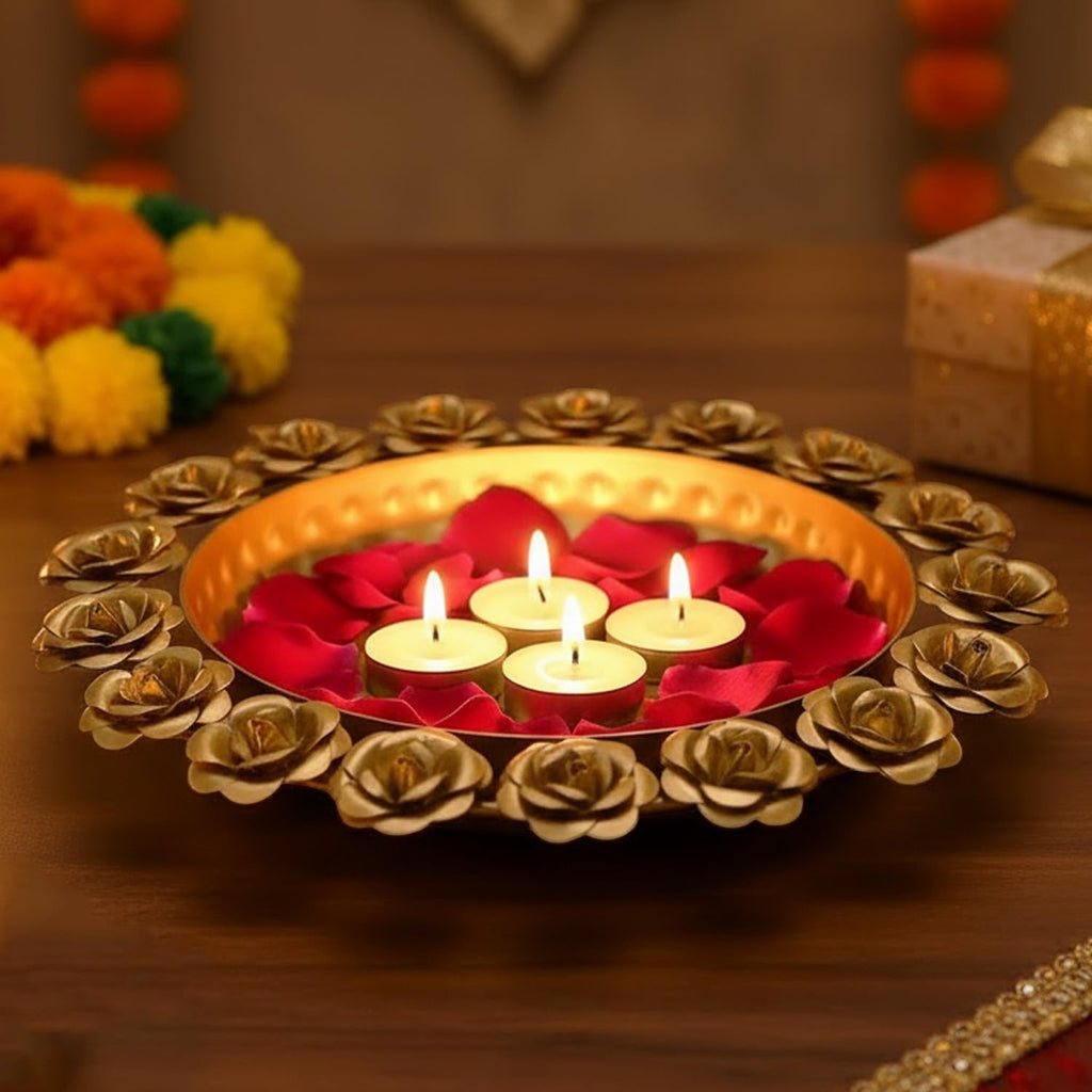 Go Hooked decorative metal urli bowl with rose accents, holding four lit tealights and red rose petals.