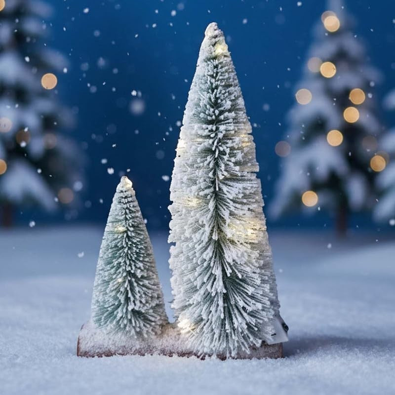 GoHooked snow-flocked mini Christmas trees with warm LED lights on a wooden base, set on a snowy surface.