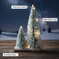 GoHooked snow-flocked mini Christmas trees with warm LED lights on a wooden base, perfect for tabletop decor.