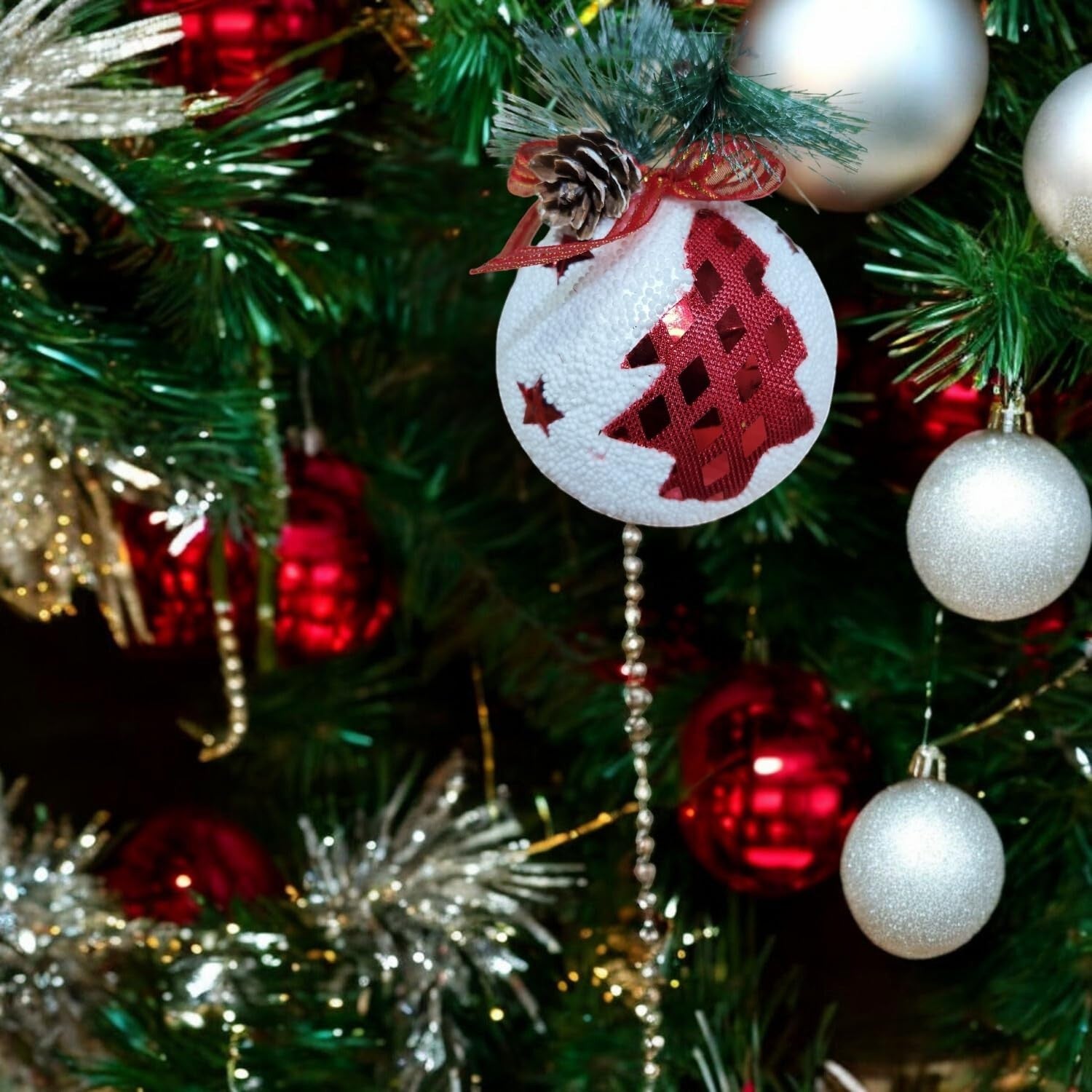 GoHooked multicolor Christmas tree ornament with glittery red tree design and pinecone accent.