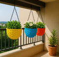 GoHooked pack of 3 multicolor round plastic hanging planters with woven texture. One holds succulents, another white flowers, and the third green plants.