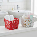 GoHooked multicolor plastic storage baskets with a decorative cutout design. One red basket holds towels, the other white basket holds toiletries.