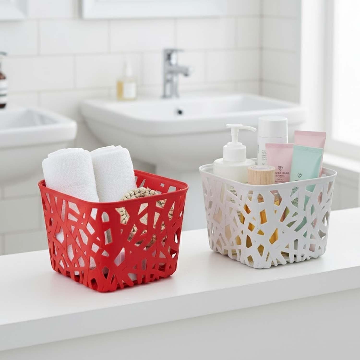 GoHooked multicolor plastic storage baskets with a decorative cutout design. One red basket holds towels, the other white basket holds toiletries.