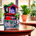 Go Hooked multicolor polyresin tabletop waterfall fountain with LED lights and red water wheel.