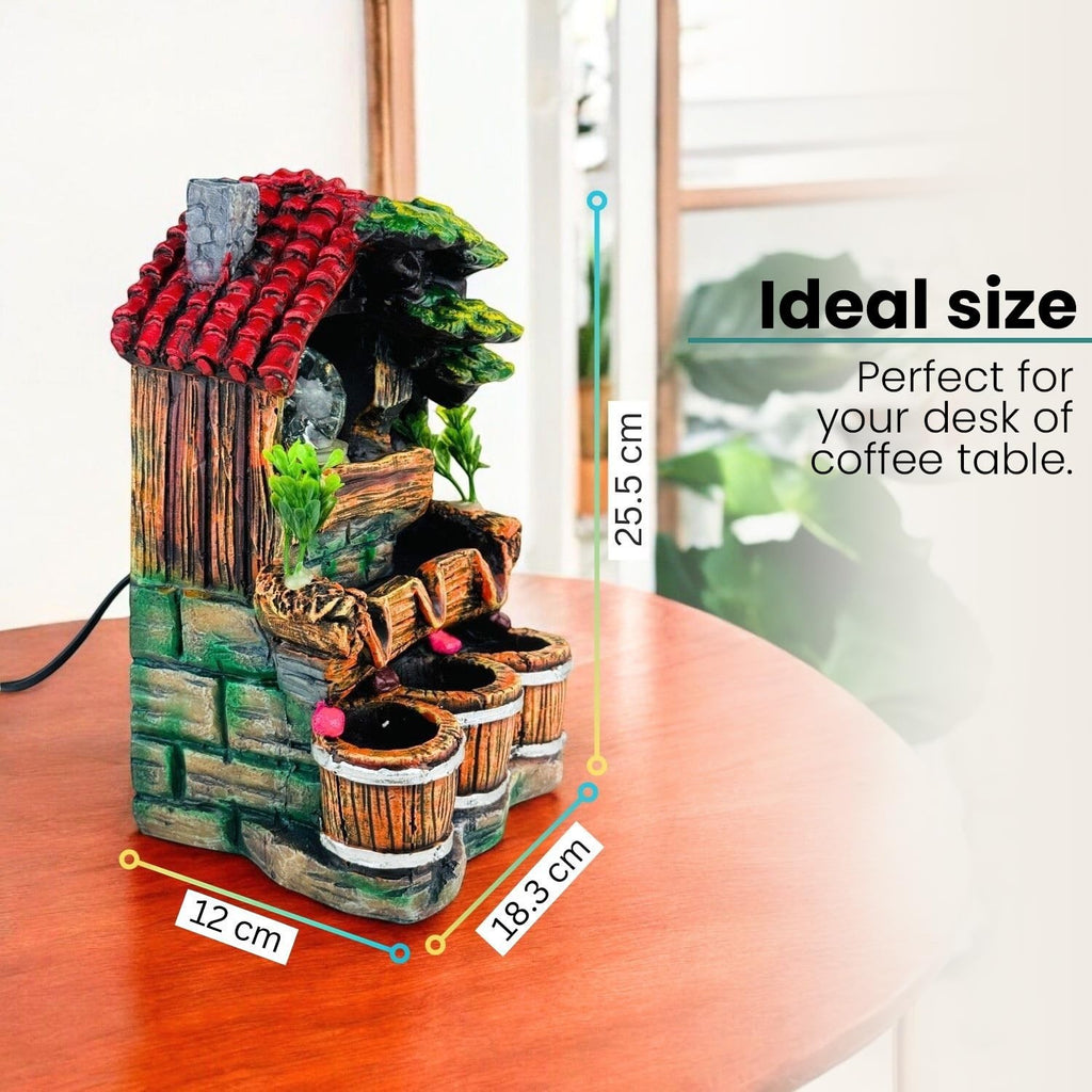 GoHooked multicolor polyresin waterfall fountain with LED lights and adjustable speed, designed as a house with barrels. 25.5 cm tall.