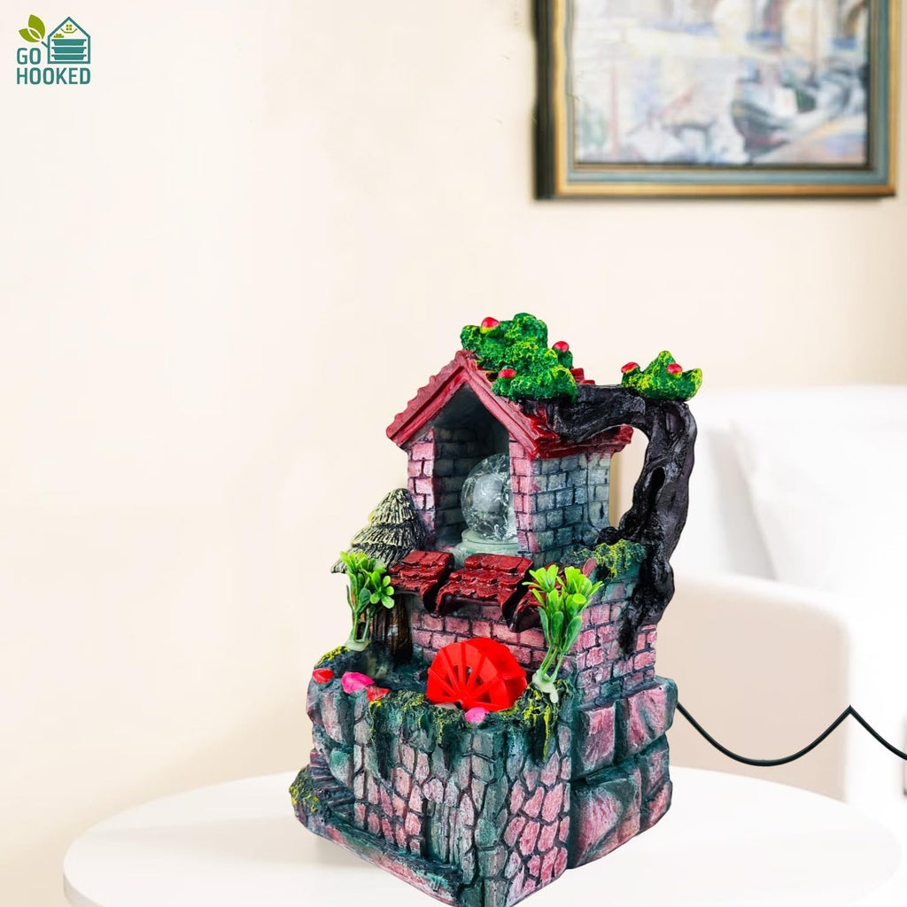 Go Hooked multicolor polyresin tabletop waterfall fountain with LED lights and adjustable speed control.