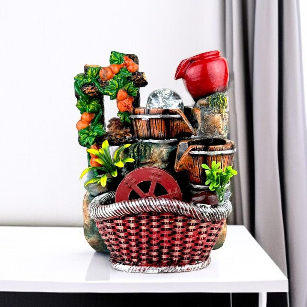 Go Hooked multicolor polyresin tabletop waterfall fountain with LED lights and adjustable speed control, featuring a red basket base.