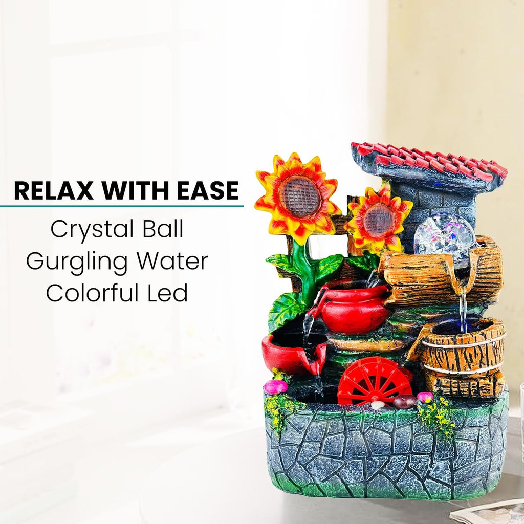 GoHooked multicolor polyresin tabletop waterfall fountain with sunflowers and LED lights. Features a crystal ball and adjustable water flow.