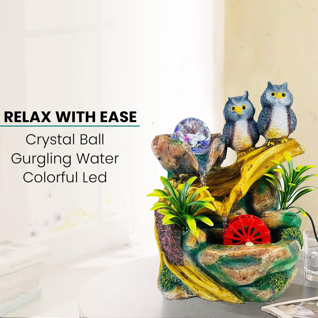 GoHooked multicolor polyresin tabletop waterfall fountain with owls, crystal ball, and LED lights. Features adjustable water flow.