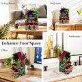 Go Hooked multicolour polyresin tabletop waterfall fountain with LED lights and adjustable speed control. Features a rustic house design with greenery and wooden buckets.