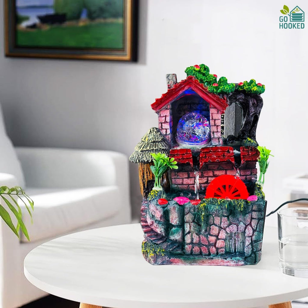 Go Hooked multicolour polyresin tabletop waterfall fountain with LED lights and red water wheel.