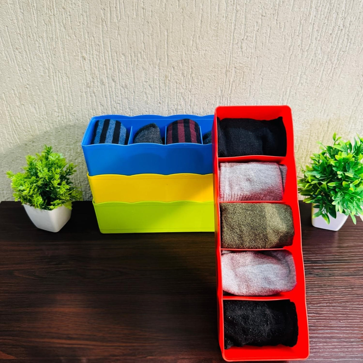 GoHooked set of 4 multicoloured plastic drawer organisers filled with socks and underwear. Space-saving and durable.