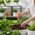 GoHooked orange and black metal hand cultivator with plastic handle, used for gardening.