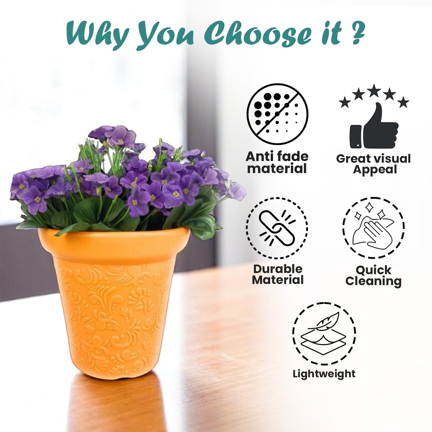 GoHooked orange plastic planter pot with embossed floral pattern holding purple flowers on a wooden table