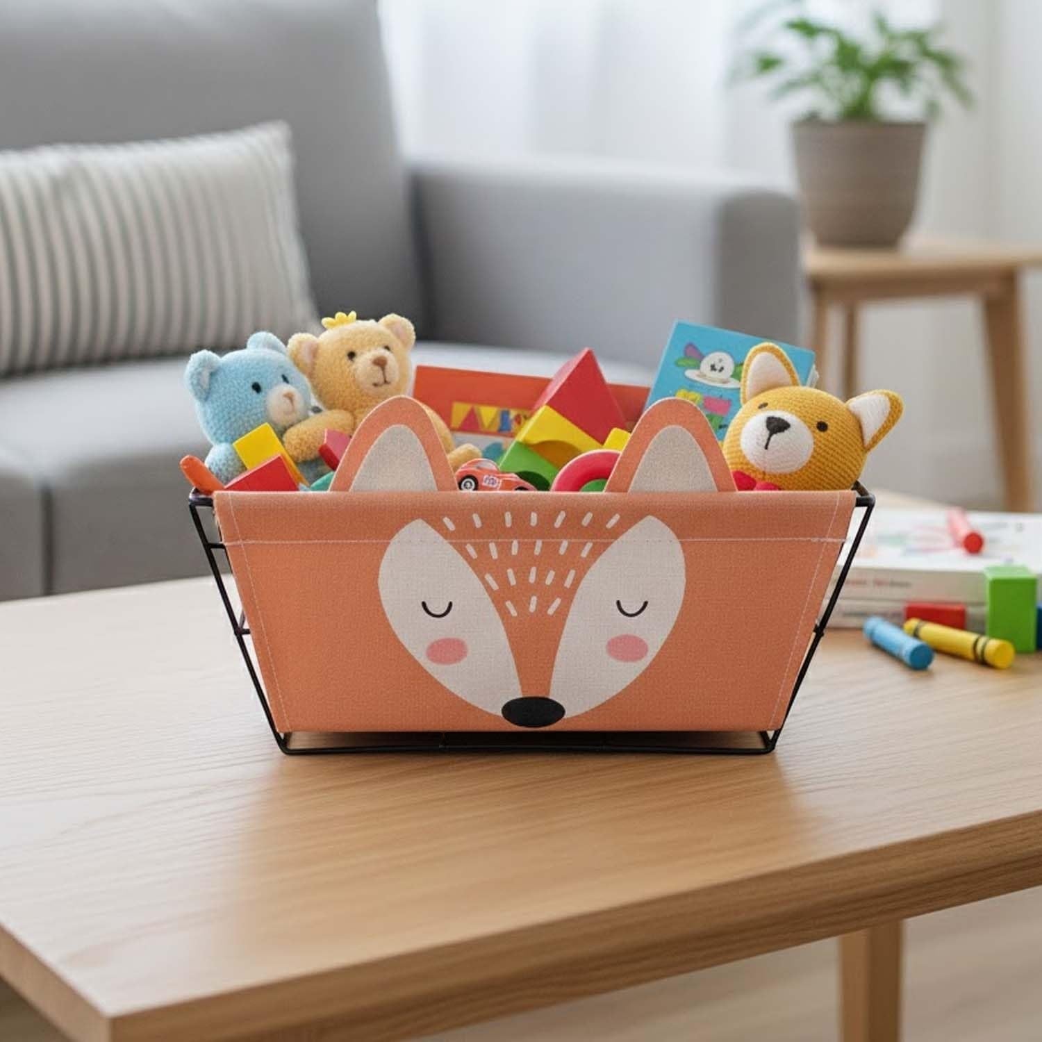 Go Hooked orange fabric storage basket with a cute fox face design, filled with children's toys.