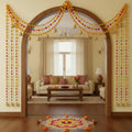 GoHooked Orange-Pink artificial marigold pom pom door hanging latkan with golden bells and beads, set of 4.