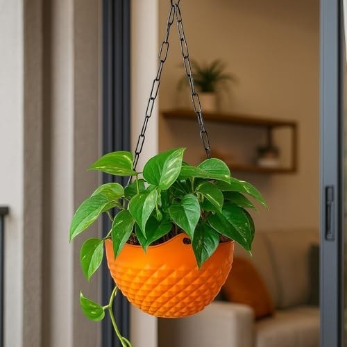 GoHooked light orange plastic hanging planter with diamond texture and metal chain, holding a green plant.