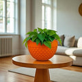 GoHooked orange plastic hanging planter with woven texture and metal chain, 8.5 inch diameter.
