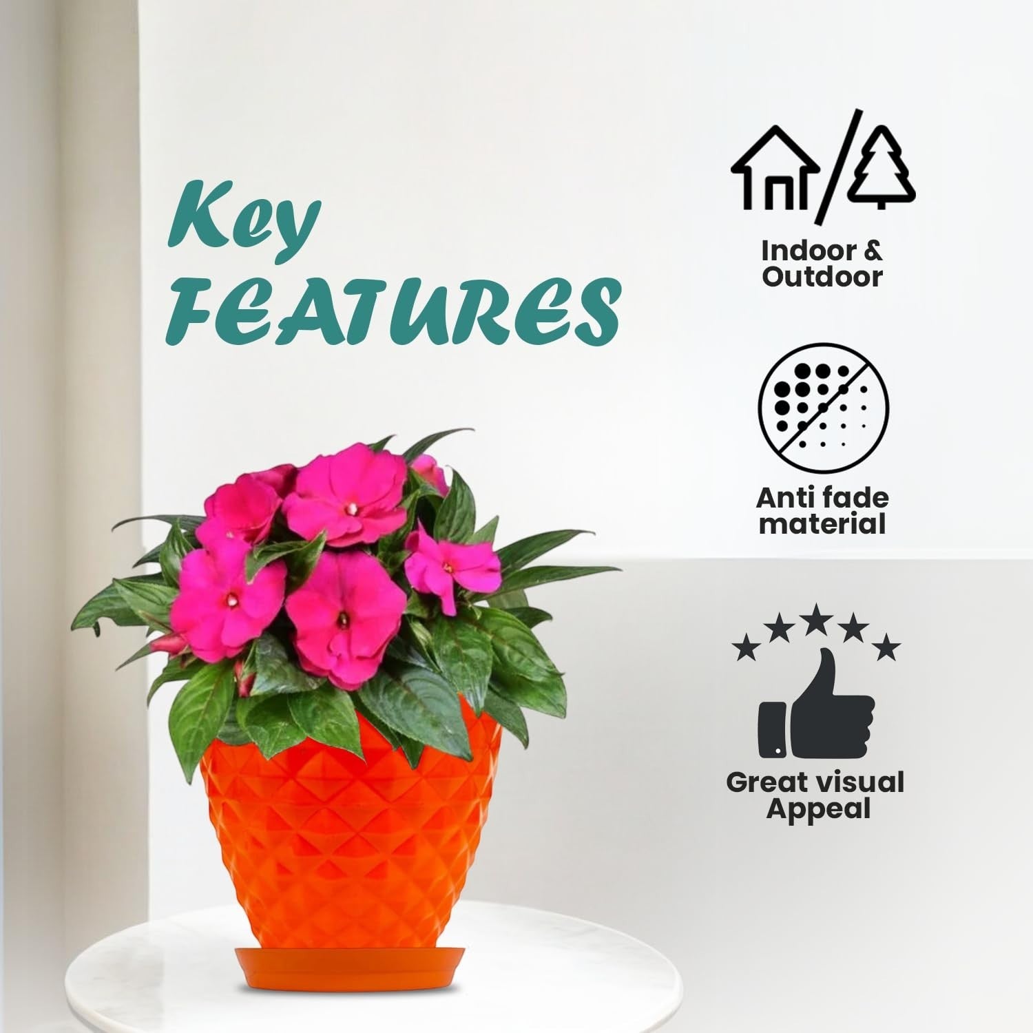 Go Hooked orange diamond-patterned plastic planter pot with pink flowers and saucer. Indoor/outdoor use.