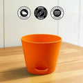 GoHooked orange plastic planter pot with self-watering feature, durable and weather-resistant.