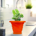 GoHooked orange plastic planter pot with saucer, 6 inch twister design for indoor/outdoor plants.