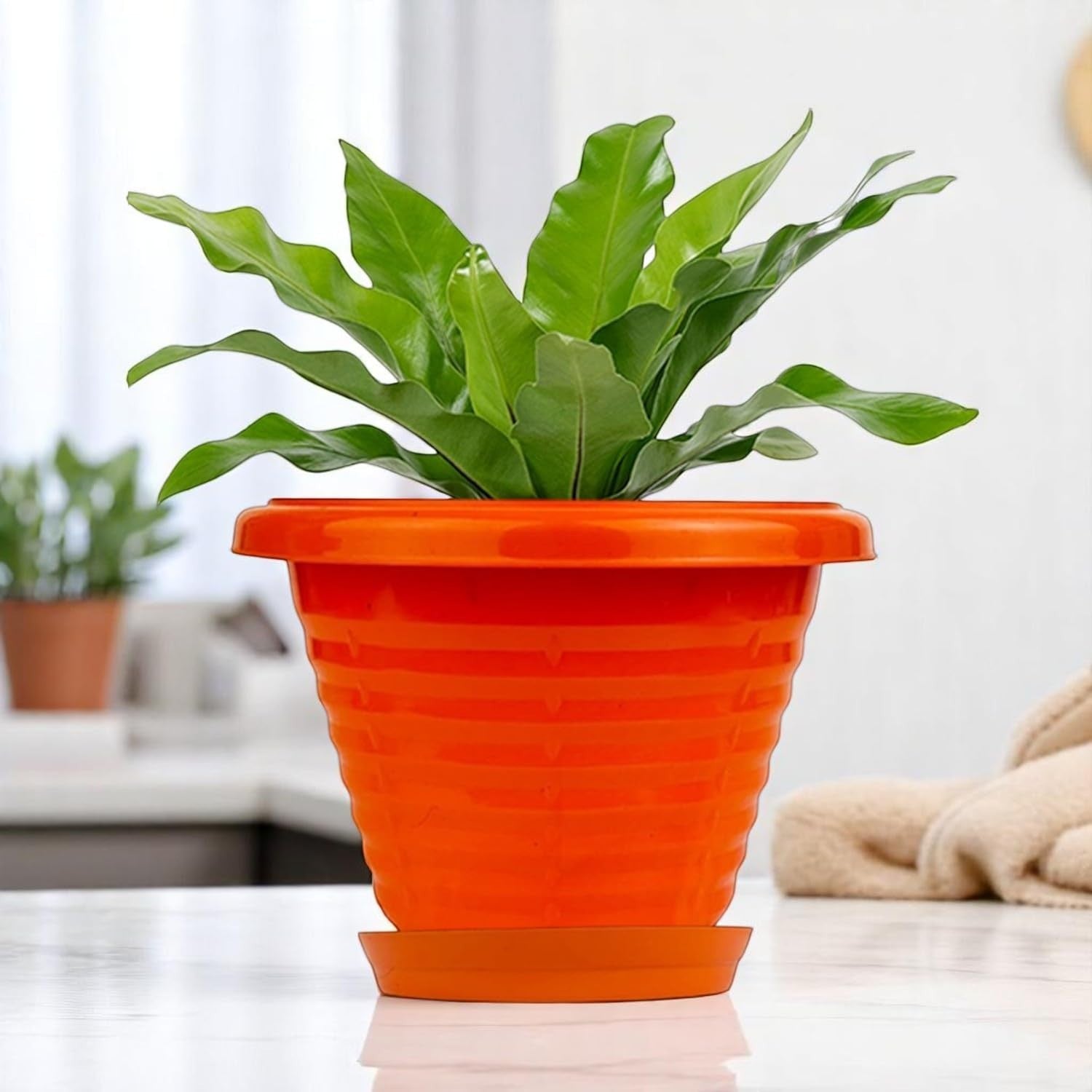 GoHooked orange plastic planter pot with saucer, 6 inch Zenith design for indoor/outdoor plants.