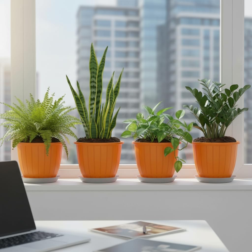 GoHooked 8-inch orange plastic planters with trays, holding snake plants, ferns, and ZZ plants on a windowsill.