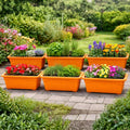 Go Hooked set of 6 orange rectangular plastic planters filled with colorful flowers and greenery, arranged on a stone patio.