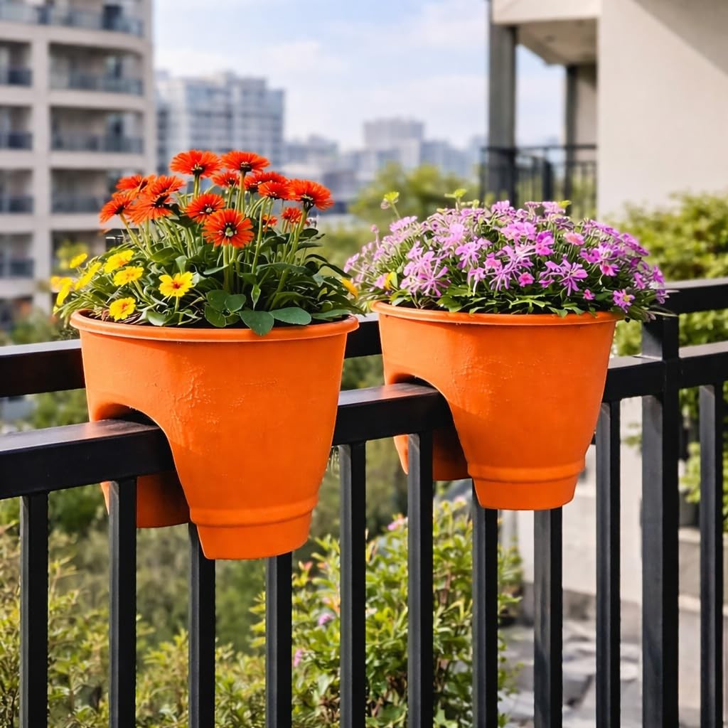 GoHooked orange plastic railing planters with orange and purple flowers on a balcony railing.