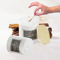GoHooked white glass jar candle with Oud Euphoria fragrance, lit by a match. Aromatherapy benefits.