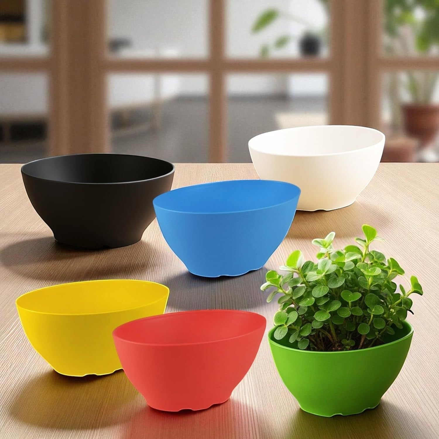 GoHooked set of 6 multicolor lightweight polymer oval plant pots, one with a plant.