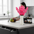 Go Hooked pink artificial flowers in a white textured vase, a realistic and low-maintenance home decor accent.
