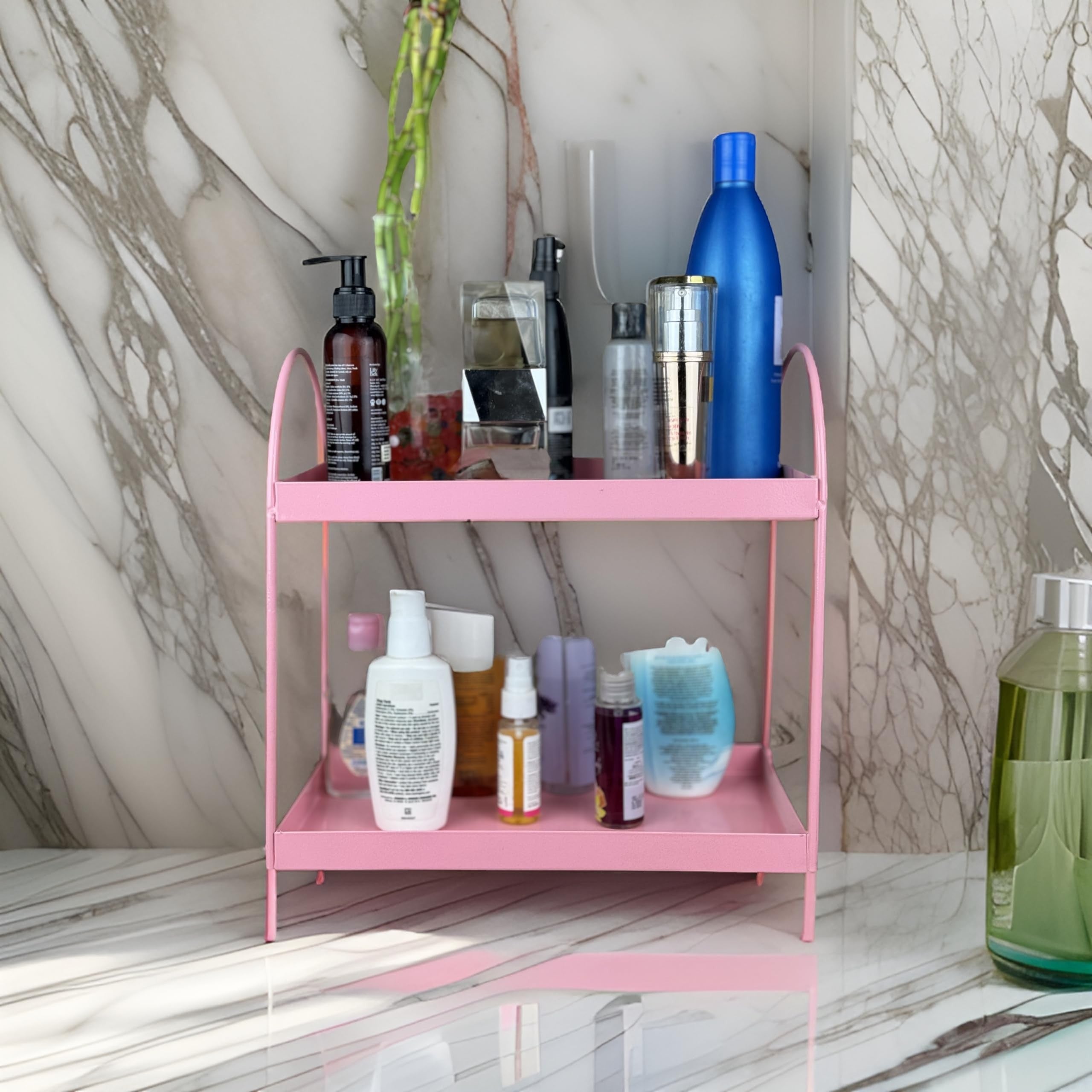 GoHooked pink metal 2-tier standing rack organizer for bathroom countertop or kitchen, holding various cosmetics and bottles.