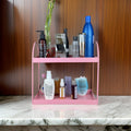 GoHooked pink metal 2-tier standing rack organizer for bathroom or kitchen countertop storage. Holds cosmetics, spices, and bottles.