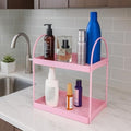 GoHooked pink metal 2-tier standing rack organizer for bathroom or kitchen countertop storage. Holds cosmetics, spices, and bottles.