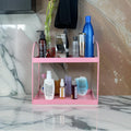 GoHooked pink metal 2-tier standing rack organizer for bathroom or kitchen countertop storage. Holds cosmetics, spices, and bottles.
