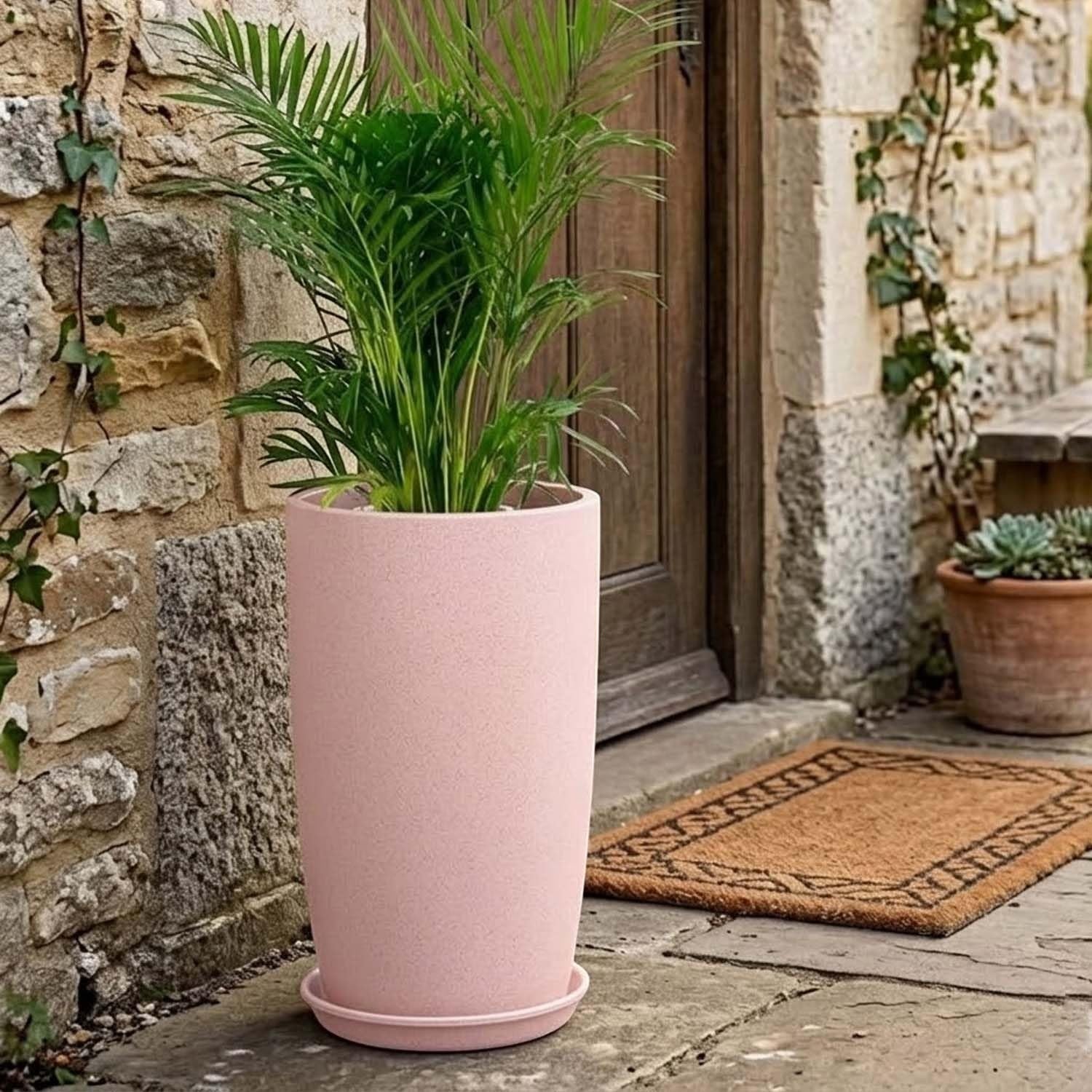 GoHooked tall pink plastic planter with a matching saucer, holding a green plant. Ideal for home or garden.