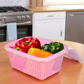 GoHooked pink plastic storage basket with zip net cover, holding bell peppers and chili peppers.