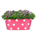GoHooked pink metal hanging planter with white polka dots, 12 inch oval shape, filled with purple and pink hydrangeas.